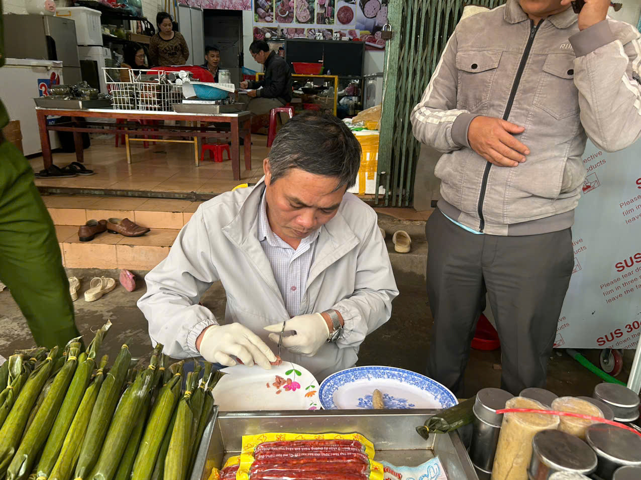 A person in gloves at a table with food AI-generated content may be incorrect.